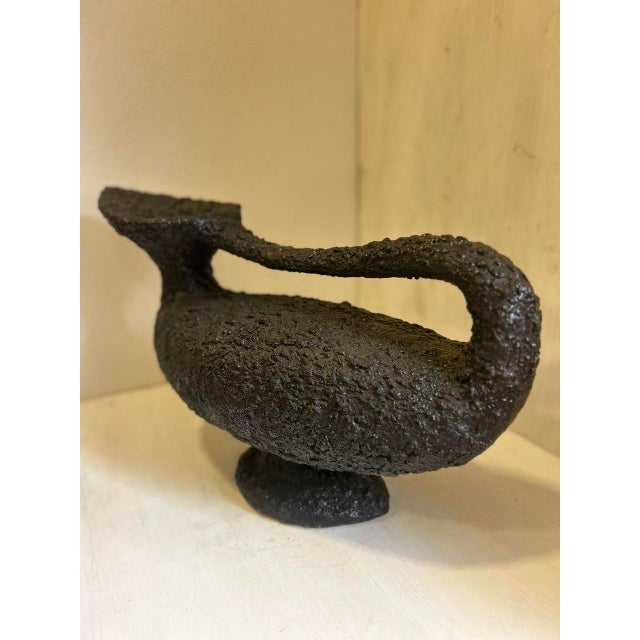 Vase made by Amilcare Rambelli in the 1960s, in black cold-painted terracotta. Its abstract shape bears the artist's...