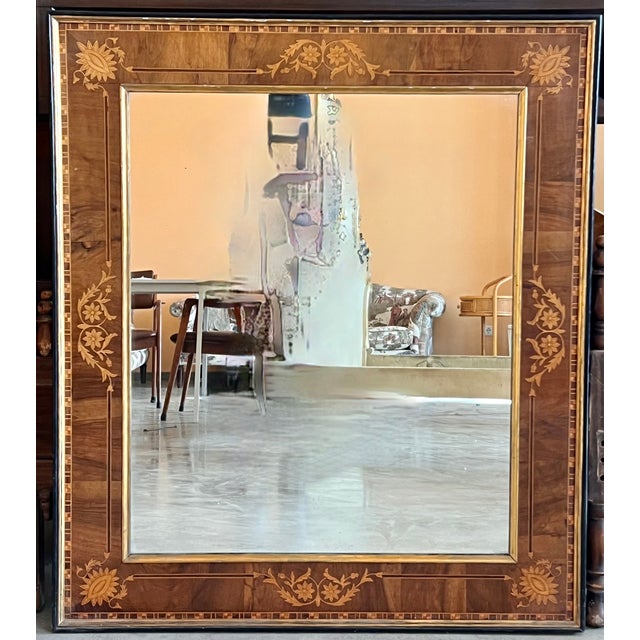 This is a beautiful antique Spanish flame mahogany and marquetry wall mirror, circa 1840. The mahogany frame is...