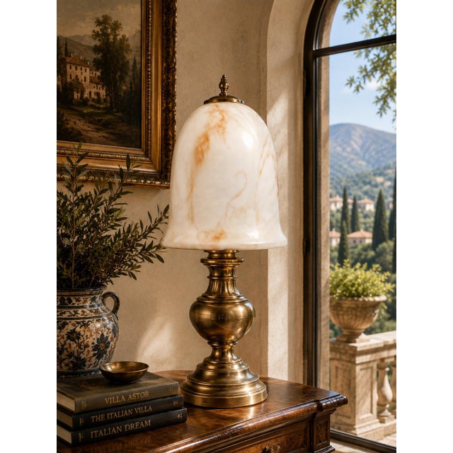 Elegant alabaster lamp shade with a graceful bell-shaped silhouette and beautiful natural veining in soft ivory, cream,...