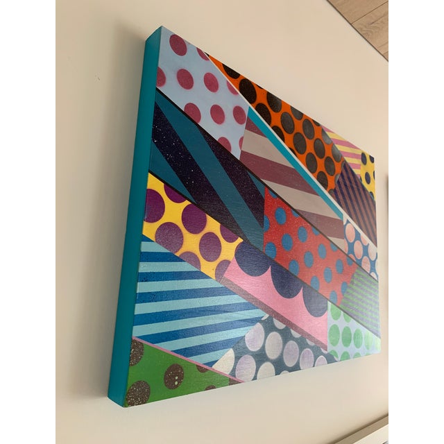 Jason Woodside’s work is characterized by vivid colors and contrasting layers of simple, geometric patterns. Taking...