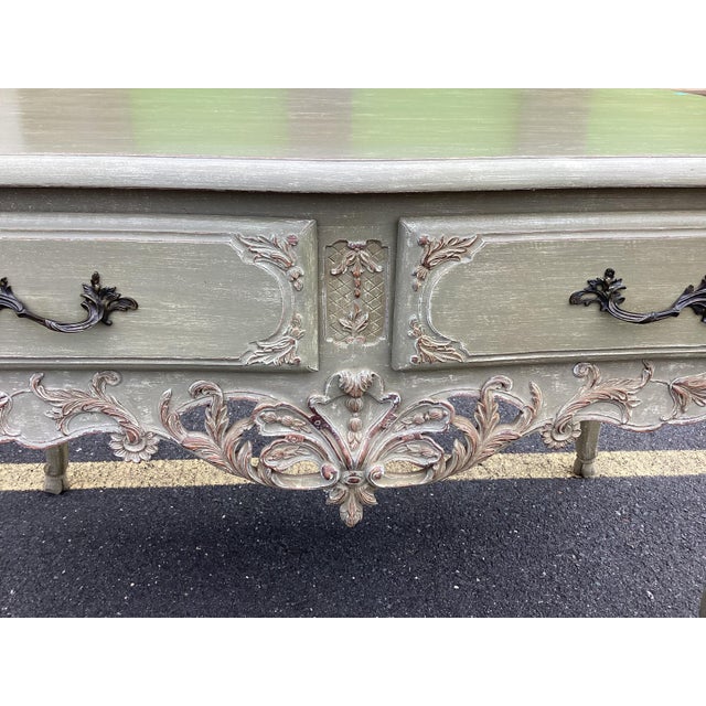 This painted French console table is beautifully carved. Throughout this piece you will find delicate carvings of shells,...