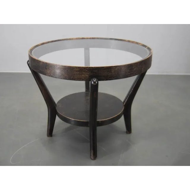 This iconic Mid-century coffee table by Czech designers Karel Kozelka and Antonín Kropáček features a distinctive bentwood...