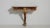 An early 19th century French Rococo-style console table with a patinated finish and a marble top, showcasing the graceful...