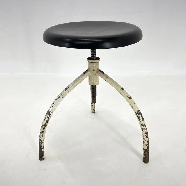 Vintage medical stool made of iron and wood. The hight is adjustable with 57 cm of the maximum hight. The wooden seat was...