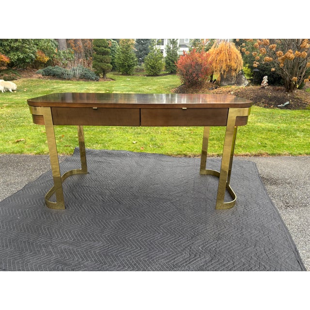 Gorgeous Showstopper walnut and brass writing desk by John Stuart. Featuring Mid-Century Modern Style offering significant...
