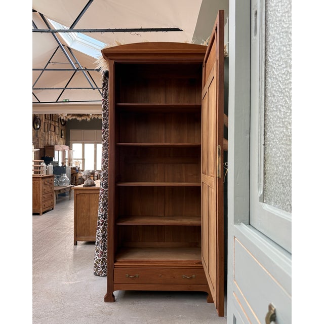 Large art nouveau bonnetière in mahogany and sapele wood, dating from the turn of the 20th century. With its...