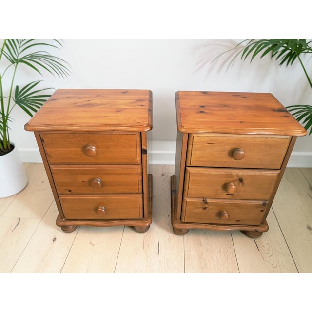 Pair of Solid Pine Country Style Bedside Chest of Drawers – 1980s - In Exceptional Condition Bring warmth and timeless...
