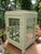An antique, small wooden box with an unusual door, whose faceted glass panes are individually set in brass. The glass...