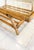Glass-top rattan coffee table in the style of Paul Frankl. The item is unmarked. The table features a glass top in a...