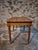 Origin: France Period: 1920s–1930s Materials: Pine (top and frame), Beech (legs) Finish: Original amber-toned shellac on...