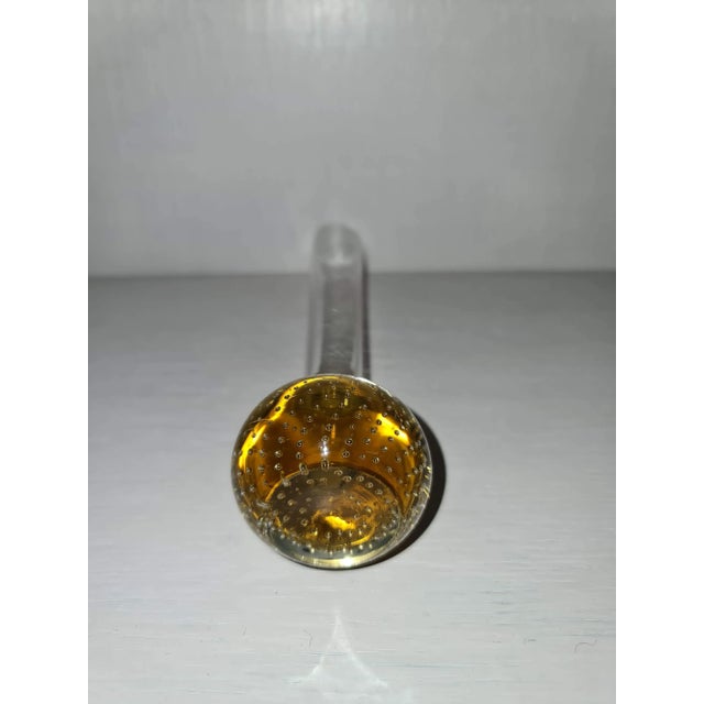 Base of yellow glass with bubbles, no damage