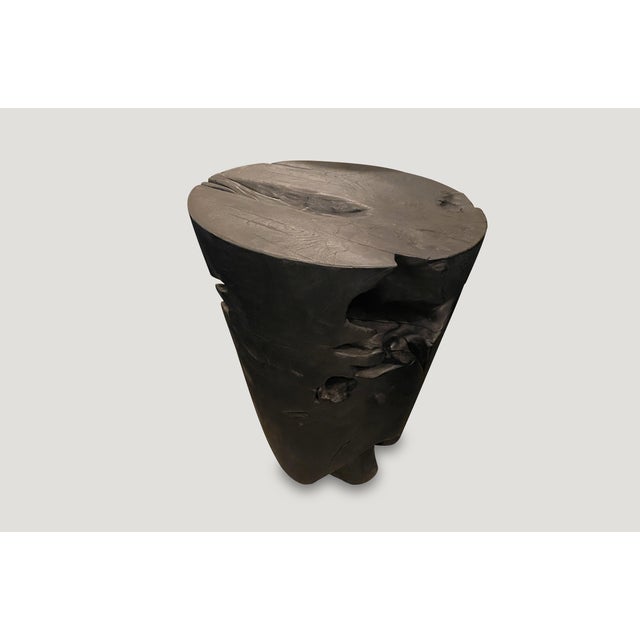 Hand carved solid reclaimed teak wood side table with a graduation from the bottom to the top. Burnt, sanded and sealed...