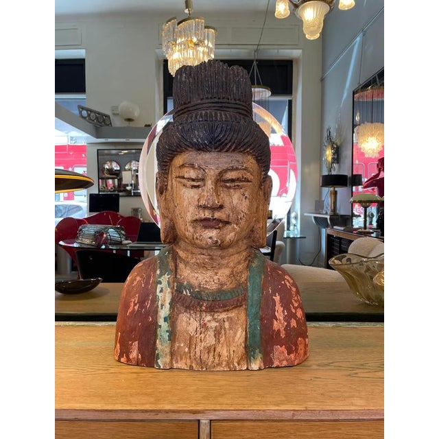 Late 19th-century carved wooden statue depicting the bust of Buddha. This Chinese sculptural work features a polychrome...