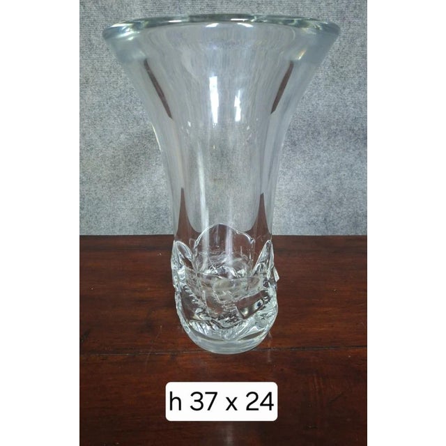Daum France crystal vase, with a modern and sculptural design. This model features an elegant flared shape resting on a...