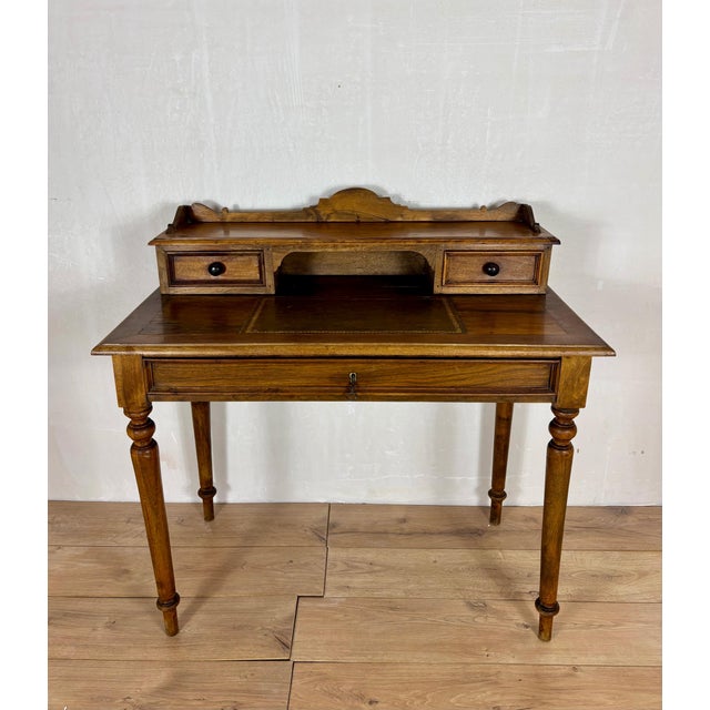 Elegant writing desk crafted in oak, featuring a refined raised gallery with two small drawers, an open central...