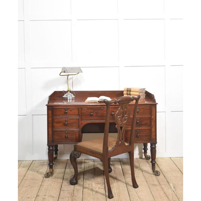 fine quality 19th century mahogany writing table, crafted with elegance and practicality in mind. The rectangular top...