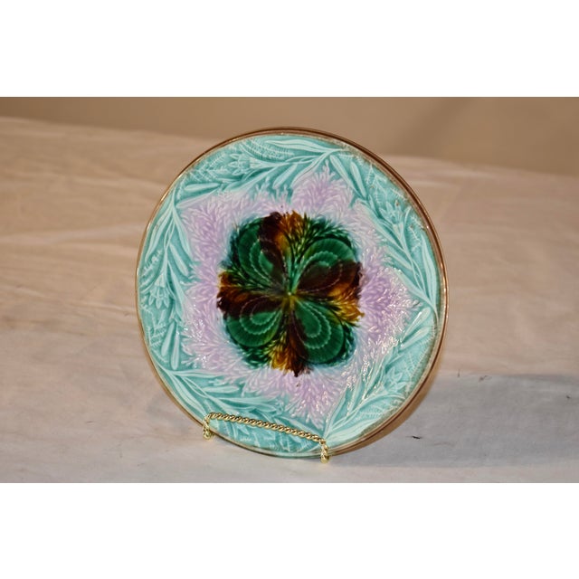 19th century Majolica plate from England. This plate is absolutely lovely! It has a hand painted brown rim, surrounding a...