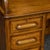 Oak Edwardian roll top desk of superior quality with fielded (bevelled) exterior panelling to all sides. The oak finish is...