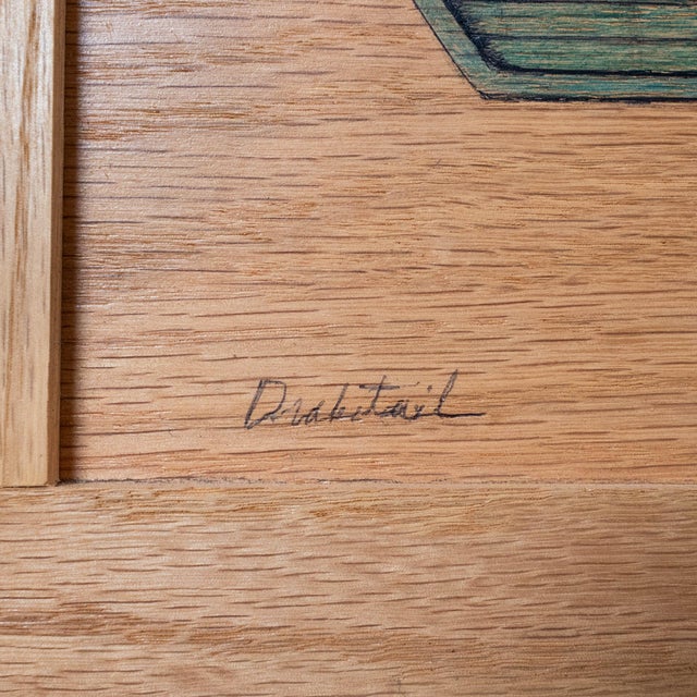 A finely crafted mid-century wood inlay artwork depicting a stylized naval ship, possibly a submarine or aircraft carrier....