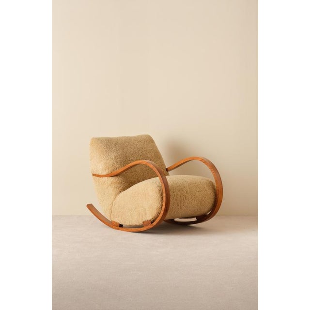 Reupholstered in honey colored sheepskin. Produced in Sweden, 1950s.