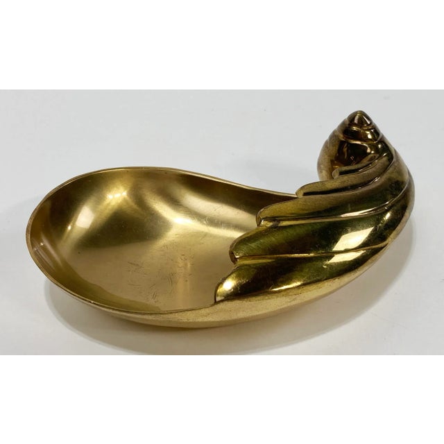 Vintage footed brass catchall dish with shell motif. Lovely patina.