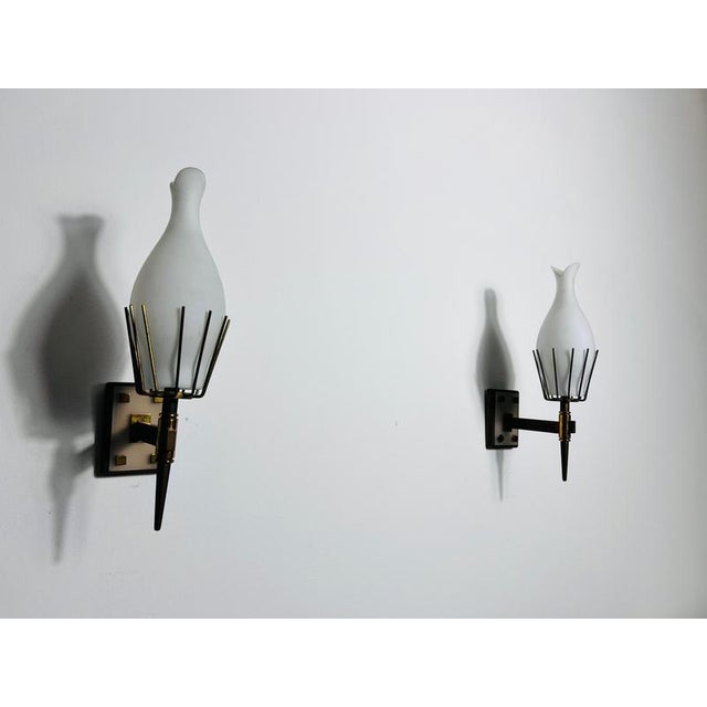 This exquisite pair of wall lamps from 1960s italy embodies the elegance and craftsmanship of mid-century modern design....