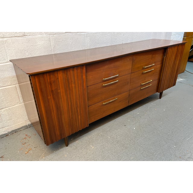 A beautifully crafted example of American mid-century modern design, this Young Manufacturing walnut lowboy dresser...