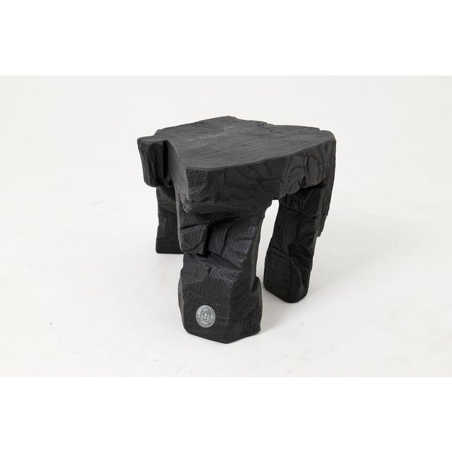 Carved from a single solid log, this piece has the weight and presence of something ancient. The top surface preserves the...