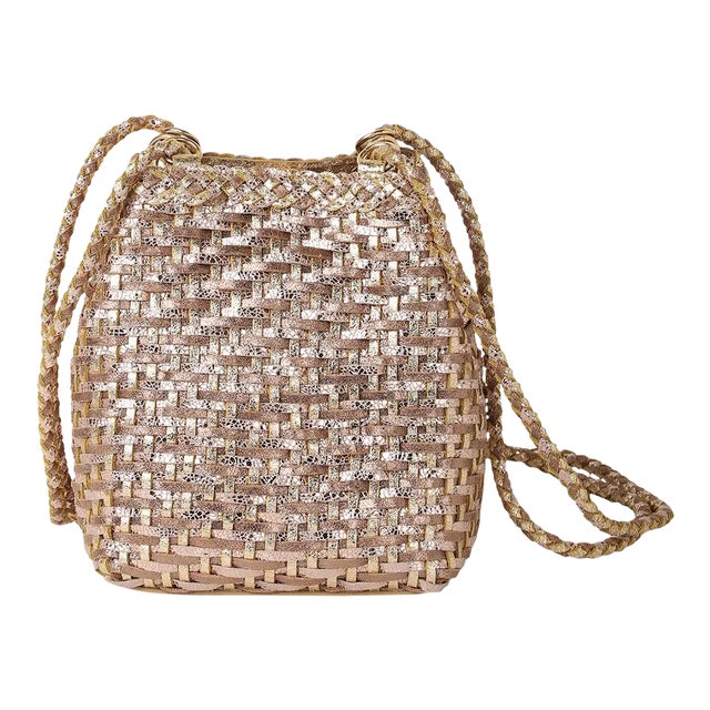 Small bucket crossbody in handwoven gold multi metallic leather. Fully lined with woven leather shoulder straps and trim.