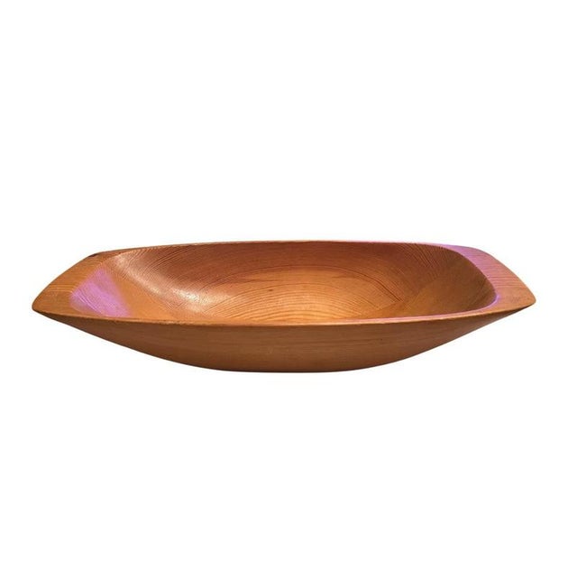 A beautifully hand-carved wooden bowl by Swedish artisan Stig Sandqvist, showcasing the minimalist and organic design...