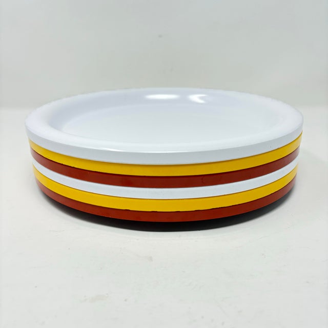 A set of six vintage Ingrid Ltd. melamine dinner plates in a a vibrant Mid-Century Modern color palette of mustard yellow,...