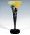 Trumpet-shaped vase with a wide flared rim resting on a stepped round foot; colourless glass with milky white and yellow...