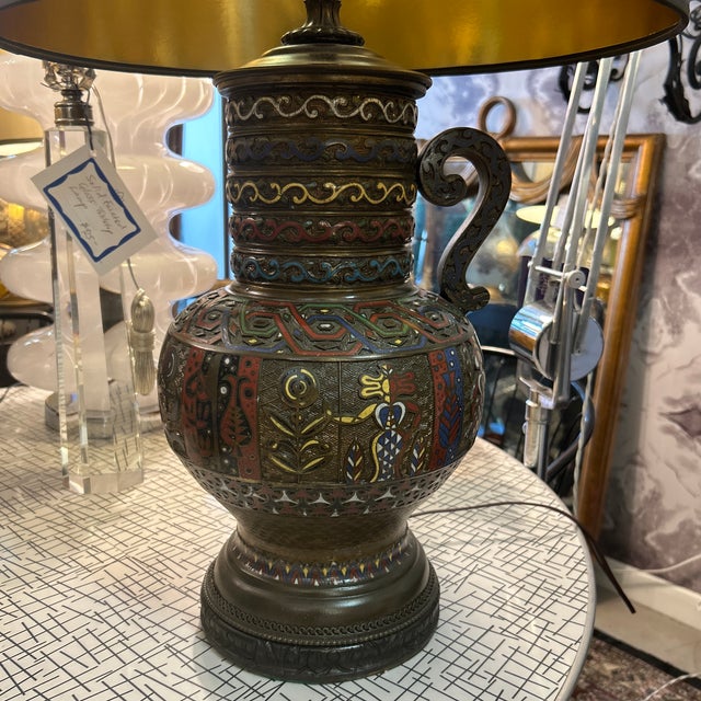 Bronze urn-style table or desk lamp with incised design throughout. There are many patterns and designs which are in a...