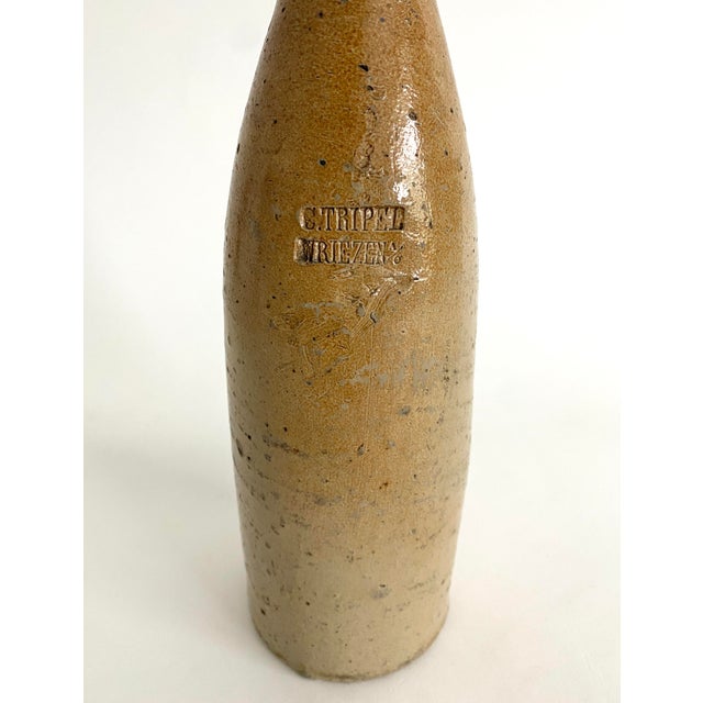 This antique German stoneware beer bottle has that organic element in its handmade imperfections and age earned patina....