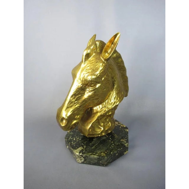 Stunning vintage sculpture, golden brass structure in the shape of a horse's head with dark marble base. Very important...