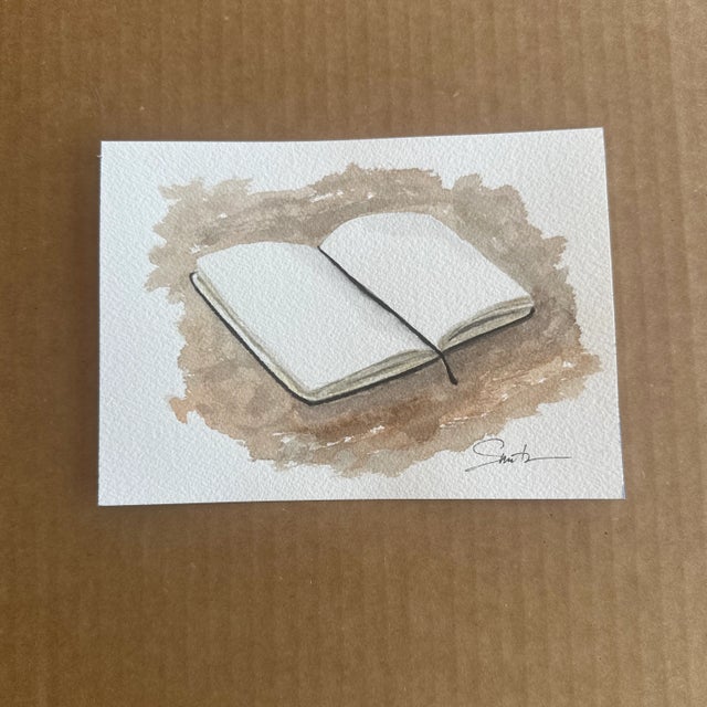 Celebrate the power of story and imagination with this serene watercolor depicting an open book resting on a textured,...