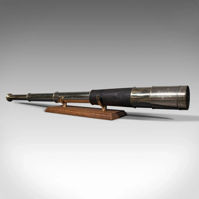 This is an antique Ross of London telescope. An English, brass three draw terrestrial refractor, dating to the early 20th...