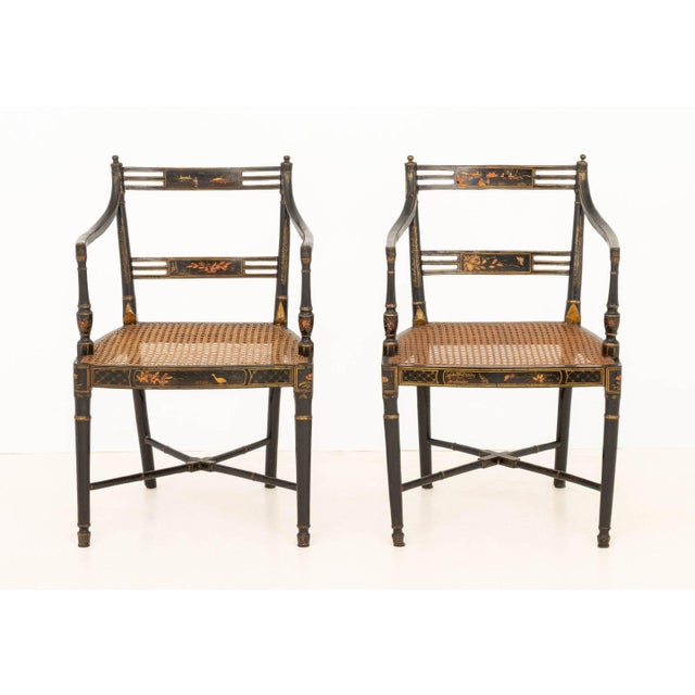 Near Pair of Japonisme Paint-Decorated and Ebonized Wood Arm Chairs, with cane-paneled seats. Slightly larger: 32" H x...