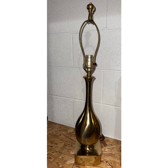 mid-century modern teardrop- or genie-form polished brass table lamp, resembling designs by makers like Laurel Lamp Co. or...