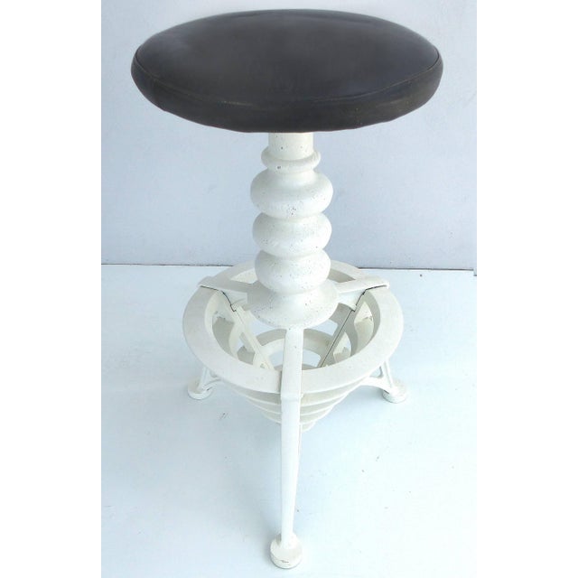 Turn of the Last Century Cast Iron Swivel Bar Stools with Leather Seats, Pair Offered is a pair of early 20th century...