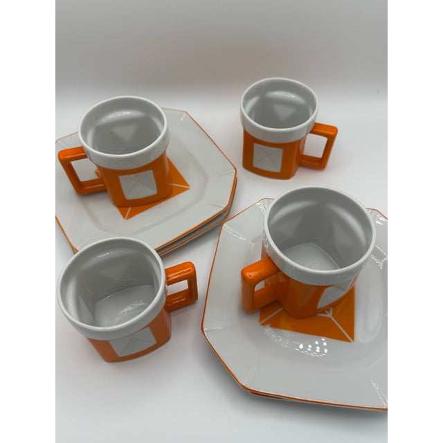 Vintage Trend by Nasco orange and white ceramic mug and saucer set featuring a retro geometric design. It comes with the...