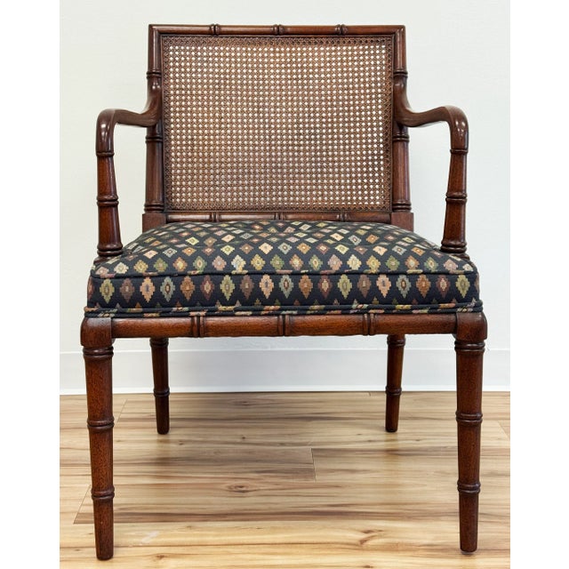 Vintage high quality solid wood frame arm chair with cane back and diamond pattern upholstery. Rich faux bamboo detailing...