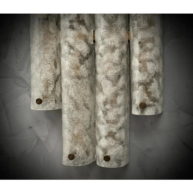 Very original wall lamp in Murano glass with a very elongated design of the glass half-shell and a unique speckled white...