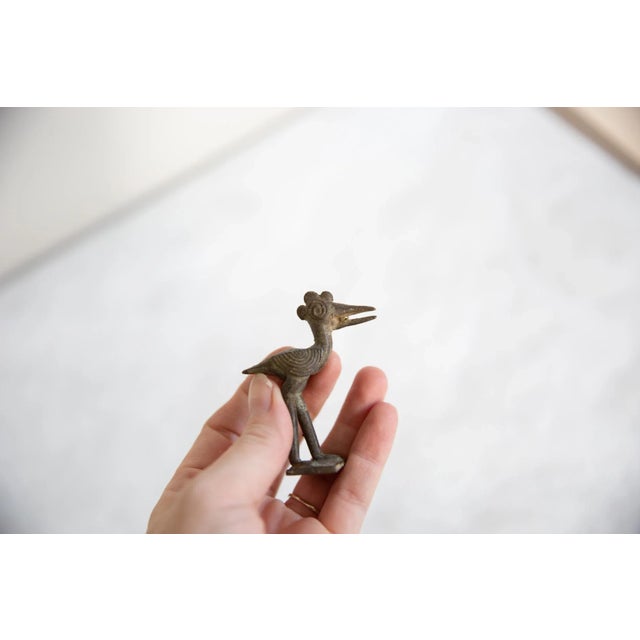 :: Vintage handmade African bronze open beaked crowed stork. Circa mid 20th century and possibly older, this piece has...