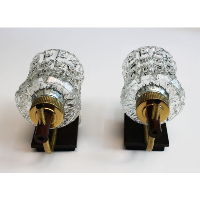 Pair of vintage wall sconces dating from the 1970s. They are distinguished by their thick, textured glass diffusers, which...
