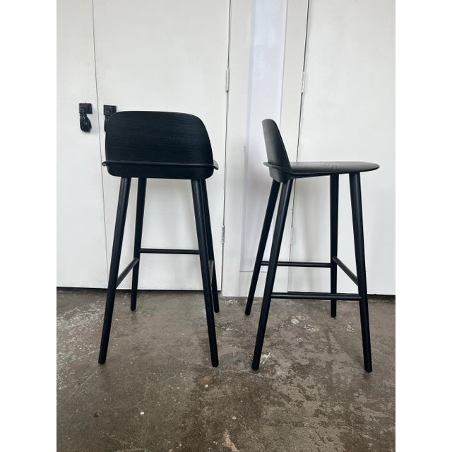 Muuto Nerd bar stools in black. Lacquer ash. Product description The Nerd Bar Stool is designed with a playfully...