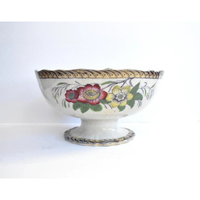 An antique, Victorian, late 19th-century Staffordshire ironstone footed punch bowl or centerpiece fruit bowl with a...