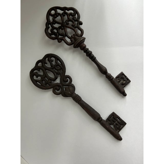Two large, beautiful, decorative cast iron keys. Add a little old world character to your decor with these scroll design...