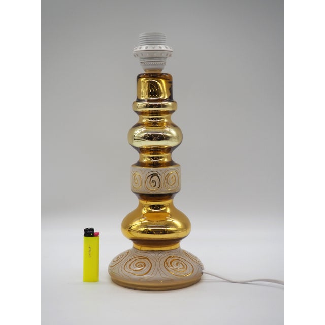 A decorative and unusual table lamp from Rosdala, known for its confident forms and handcrafted lighting pieces. The lamp...