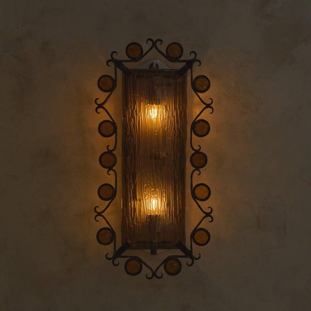 A rare Italian wall sconce from the 1970s, attributed to Longobard. Rising to 29 inches in height, the form is vertical...